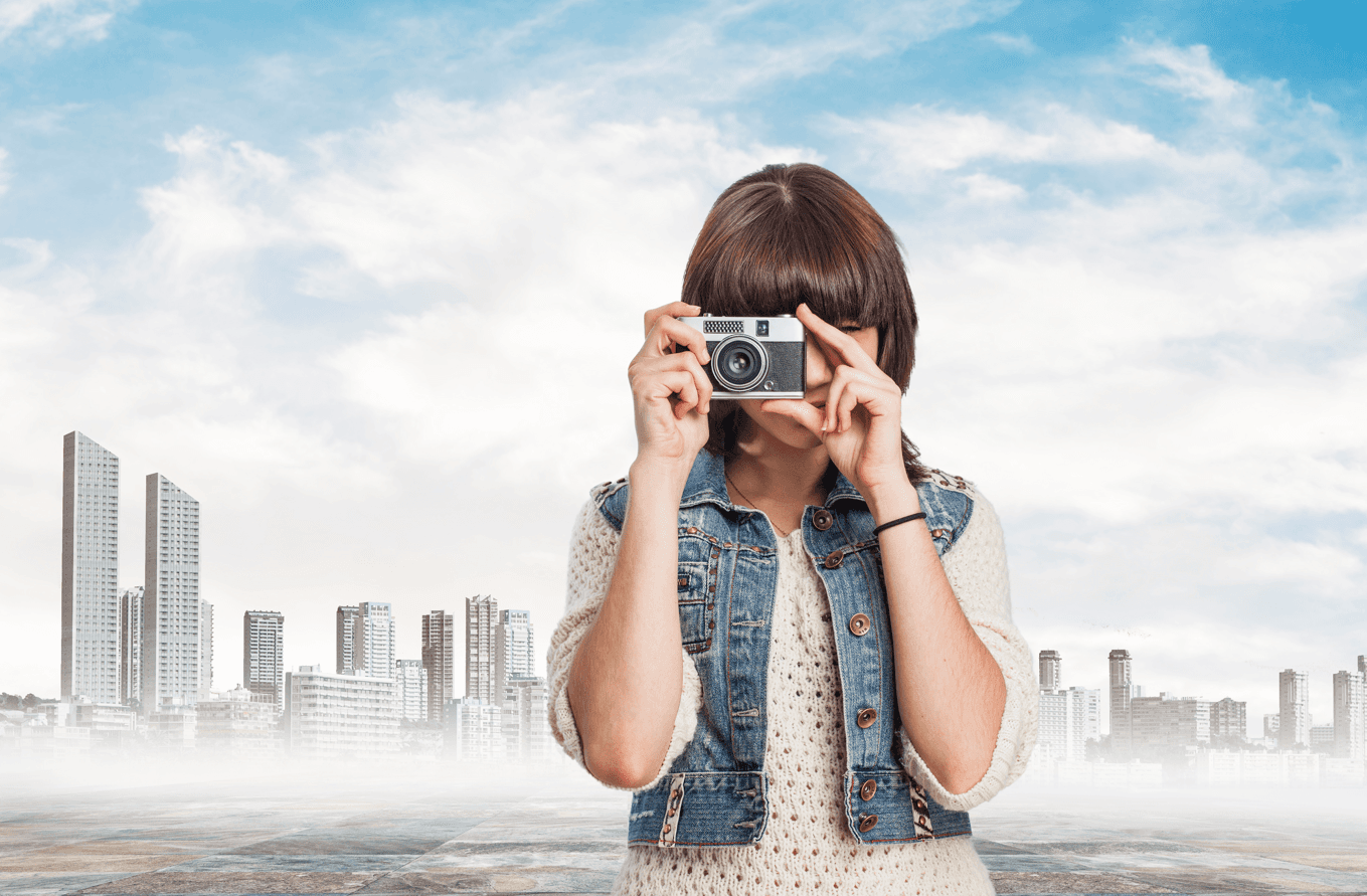 Girl taking a picture with city background