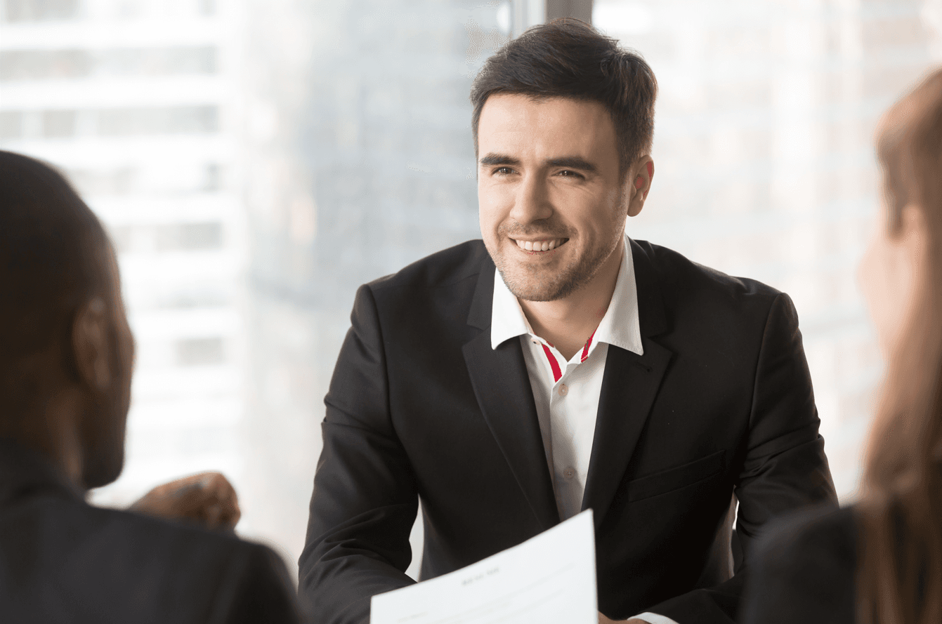 Man focusing on conversation with interviewers